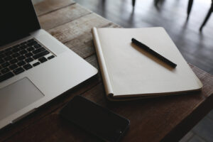 This is a picture of a blank notebook and a laptop.