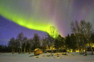 Northern Lights (Aurora borealis) over snowscape.