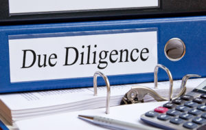 Binder with the words "Due Diligence" written on the side.