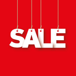Sale - the word of the white letters hanging on the ropes on a red background