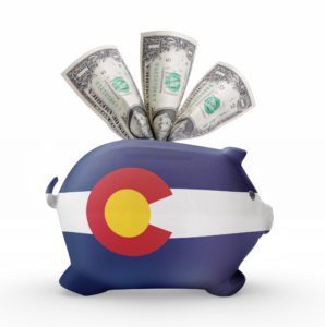 Side view of a piggy bank with the flag design of colorado.