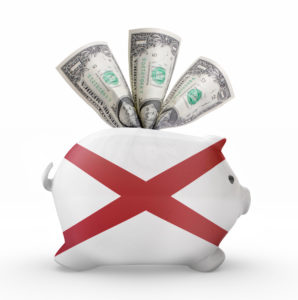 Side view of a piggy bank with the flag design of Alabama.