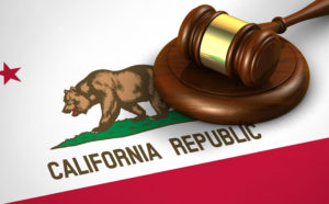 California US state law, legal system and justice concept with a 3D rendering of a gavel on Californian flag.