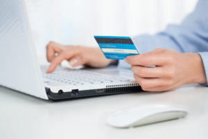 Close up of female hands making online payment