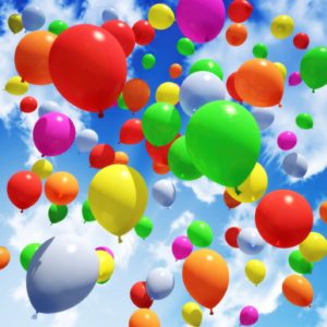 This is a picture of some balloons floating in the sky. 